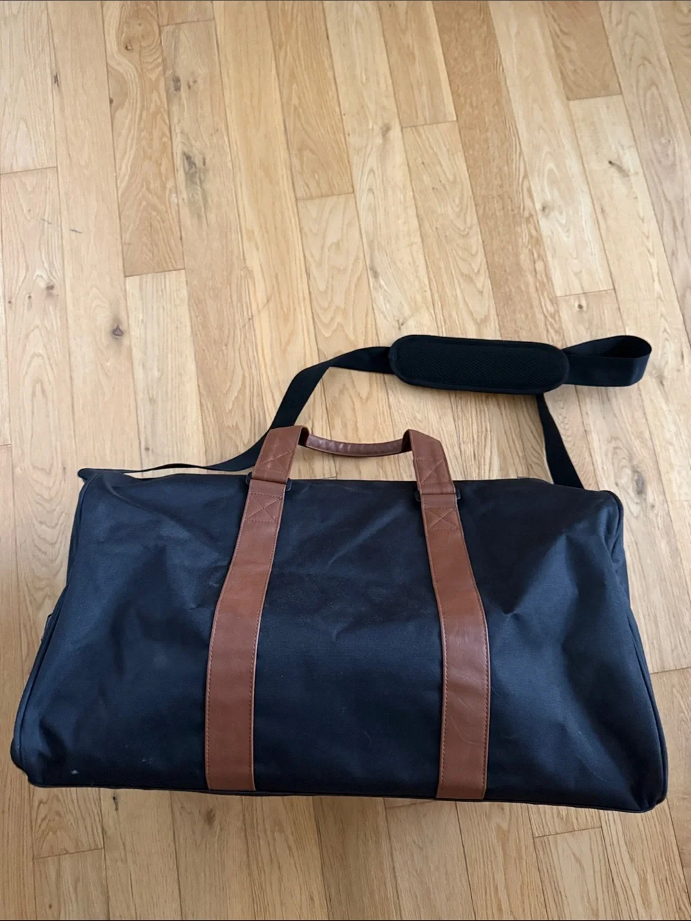 Herschel Supply Company Black Duffel with Brown Straps and White Piping. 43L.